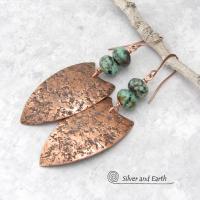 These large copper earrings feature handcrafted copper shields with a rustic, organic hammered texture accented with earthy, natural African turquoise stones. Big and bold, they have an ethnic tribal vibe and will make a striking statement. 