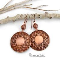 These handcrafted copper earrings have a beautifully detailed embossed sun medallion texture with an oxidized finish and are accented with brushed satin copper beads. Big and bold, they'll make a striking statement. Unique and versatile, they are lightweight and comfortable to wear and will look great with all wardrobe styles. Handmade in the USA by Silver and Earth Jewelry.