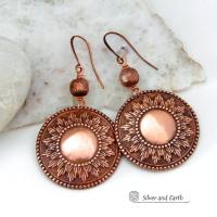 These handcrafted copper earrings have a beautifully detailed embossed sun medallion texture with an oxidized finish and are accented with brushed satin copper beads. Big and bold, they'll make a striking statement. Unique and versatile, they are lightweight and comfortable to wear and will look great with all wardrobe styles. Handmade in the USA by Silver and Earth Jewelry.