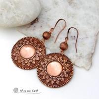 These handcrafted copper earrings have a beautifully detailed embossed sun medallion texture with an oxidized finish and are accented with brushed satin copper beads. Big and bold, they'll make a striking statement. Unique and versatile, they are lightweight and comfortable to wear and will look great with all wardrobe styles. Handmade in the USA by Silver and Earth Jewelry.