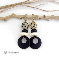 These handcrafted earrings feature matte black glass circle hoops accented with Dalmatian jasper gemstones, African bone and black glass beads. Unique and fun to wear, they have an earthy natural style with boho chic flair that makes a striking statement. They'll make a great gift for a natural stone lover - or a nice addition to your own jewelry wardrobe. 