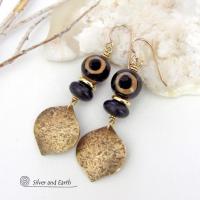 These handcrafted gold brass earrings have a contemporary modern style with an ethnic boho vibe. They feature brass drops with a lightly hammered texture accented with Tibetan eye agate gemstones, black glass and shiny brass beads. Bold and unique, they'll make a striking statement. Handmade in the USA by Silver and Earth Jewelry. 