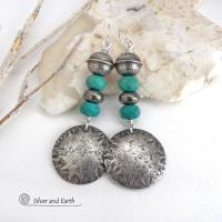 These sterling silver earrings have a southwest Santa Fe style and feature a stack of faceted blue turquoise gemstones and gray pyrite gemstones and are topped off with Native American made stamped sterling silver beads. Unique, bold and striking -- they're sure to make a statement. Perfect for anyone that loves southwest style jewelry. The earrings are handmade and are a beautiful example of southwest style jewelry. Handmade by Silver and Earth, a New Mexico True Certified business.