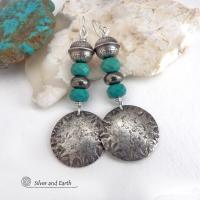 These sterling silver earrings have a southwest Santa Fe style and feature a stack of faceted blue turquoise gemstones and gray pyrite gemstones and are topped off with Native American made stamped sterling silver beads. Unique, bold and striking -- they're sure to make a statement. Perfect for anyone that loves southwest style jewelry. The earrings are handmade and are a beautiful example of southwest style jewelry. Handmade by Silver and Earth, a New Mexico True Certified business.