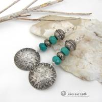 These sterling silver earrings have a southwest Santa Fe style and feature a stack of faceted blue turquoise gemstones and gray pyrite gemstones and are topped off with Native American made stamped sterling silver beads. Unique, bold and striking -- they're sure to make a statement. Perfect for anyone that loves southwest style jewelry. The earrings are handmade and are a beautiful example of southwest style jewelry. Handmade by Silver and Earth, a New Mexico True Certified business.