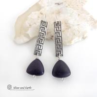 These handcrafted sterling silver earrings have a Greek key pattern and are accented with triangular-shaped black onyx stones with a matte finish. They have a contemporary modern vibe that coordinates beautifully with all wardrobe styles.Bold and unique, these earrings are perfect for women that love unusual jewelry. Handmade by SilverandEarth Jewelry.
