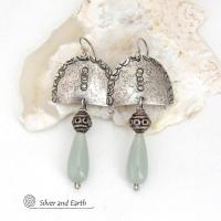 These unique sterling silver earrings have a funky bohemian tribal flair. They feature handcrafted sterling silver shapes with a hand textured design accented with natural green aventurine gemstones and vintage silver beads.