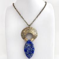 A stunning natural lapis lazuli gemstone is accented with a handcrafted gold brass crescent moon in this bold exotic necklace. The stone has a beautiful blue hue with a natural matrix of white and silvery pyrite inclusions. Unique and one-of-a-kind, it has an "Old World" Egyptian style and flair that makes a striking statement.