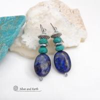 These handcrafted earrings feature natural lapis lazuli oval shaped gemstones accented with faceted turquoise and faceted hematite gemstones and textured silver pewter beads. Full of sundance style and southwestern charm, they'll coordinate well with all wardrobe types. Handmade in the USA by Silver and Earth Jewelry - a Certified New Mexico True business.