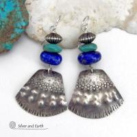 Bold and striking, these handcrafted earrings feature uniquely textured sterling silver accented with natural turquoise and lapis gemstones. They are topped off with Native style oxidized sterling silver beads with a rich, corrugated texture. They have a modern southwestern flair and are perfect for women that love to wear one-of-a-kind artisan handcrafted jewelry. Handmade in the USA by Silver and Earth - a New Mexico True Certified business.