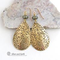 These handcrafted gold brass teardrop earrings have a hand stamped texture and are accented with natural silver pyrite gemstone beads. They have a modern contemporary style that coordinates beautifully with all wardrobe types.  MEASUREMENTS: Total length: 2-3/8” from top of bronze ear wires and 1” at widest point. Created out of solid gold brass; the shapes were hand stamped for texture; oxidized to enhance the detail. Handmade in the USA by Silver and Earth Jewelry.
