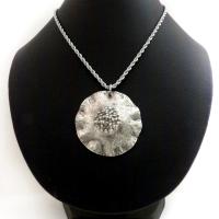 This handcrafted sterling silver necklace has a modern, earthy organic vibe. Perfect for everyday wear - it goes with everything. It features a large sterling silver circle with a rustic, hand forged texture and crimped ruffled edges.  Big and bold, it's sure to make an eye-catching statement. Handmade in the USA by Silver and Earth, a New Mexico True Certified business.  