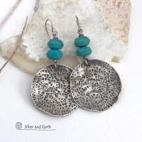 These handcrafted earrings feature large sterling silver round dangles with a hand stamped texture accented with natural turquoise gemstones with a faceted finish. Big and bold, they have a modern style with southwestern flair that looks great with all wardrobe types. Perfect for women that love large earrings and bold statement jewelry. Handmade in the USA by Silver and Earth Jewelry, a New Mexico True Certified business.