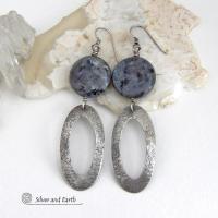 Modern, earthy & chic - these earrings feature big round natural larvikite gemstones accented with long sterling silver hoop dangles. The stones have a pearly, grayish black hue - along with blue iridescent flashes of light which cast off a natural shimmer & shine. They have a modern, contemporary style that coordinates beautifully with all wardrobe types. Larvikite originates from the Larvik region in Norway and is also called Norwegian moonstone and black labradorite. 