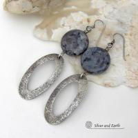 Modern, earthy & chic - these earrings feature big round natural larvikite gemstones accented with long sterling silver hoop dangles. The stones have a pearly, grayish black hue - along with blue iridescent flashes of light which cast off a natural shimmer & shine. They have a modern, contemporary style that coordinates beautifully with all wardrobe types. Larvikite originates from the Larvik region in Norway and is also called Norwegian moonstone and black labradorite. 