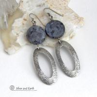 Modern, earthy & chic - these earrings feature big round natural larvikite gemstones accented with long sterling silver hoop dangles. The stones have a pearly, grayish black hue - along with blue iridescent flashes of light which cast off a natural shimmer & shine. They have a modern, contemporary style that coordinates beautifully with all wardrobe types. Larvikite originates from the Larvik region in Norway and is also called Norwegian moonstone and black labradorite. 