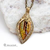 This necklace features a golden brown carved Mother of Pearl leaf accented against a handcrafted gold brass base. I hand sawed the base out of solid gold brass sheet and stamped the metal with a leaf pattern to "echo" the Mother of Pearl leaf. Unique and one-of-kind, it'll make a great gift for a nature lover - or a nice addition to your own jewelry wardrobe. It comes on an 18" antiqued brass chain with lobster claw closure. Handmade in the USA by Silver and Earth Jewelry. 