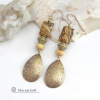 These handcrafted earrings feature gold brass teardrop dangles with a lightly hammered organic texture accented with natural picture jasper stones, brass and fossilized beige coral beads. They have an earthy natural style that coordinates beautifully with all wardrobe styles. Earrings have a coordinating necklace sold separately. Handmade in the USA by Silver and Earth Jewelry.