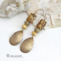 These handcrafted earrings feature gold brass teardrop dangles with a lightly hammered organic texture accented with natural picture jasper stones, brass and fossilized beige coral beads. They have an earthy natural style that coordinates beautifully with all wardrobe styles. Earrings have a coordinating necklace sold separately. Handmade in the USA by Silver and Earth Jewelry.