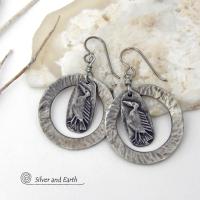 These handcrafted earrings feature silver pewter circle hoops with a hammered texture accented with silver pewter bird charms dangling in front. Lightweight and comfortable to wear, they have a casual earthy style with rustic flair that coordinates with all wardrobe types. They'll make a great gift for a nature / bird lover - or a unique addition to your own jewelry wardrobe. Handmade in the USA by Silver and Earth Jewelry.