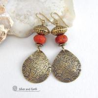 These handcrafted gold brass earrings have a hand stamped and hammered texture and are accented with faceted red coral, brass tribal style beads and faceted hematite stone beads with an electroplated champagne gold tone finish. Big and bold, they have a modern boho chic vibe with a tribal flair that makes a striking statement. Perfect for women that love to wear unique and eye-catching artisan handcrafted jewelry. Handmade in the USA by Silver and Earth Jewelry.