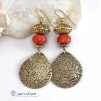 These handcrafted gold brass earrings have a hand stamped and hammered texture and are accented with faceted red coral, brass tribal style beads and faceted hematite stone beads with an electroplated champagne gold tone finish. Big and bold, they have a modern boho chic vibe with a tribal flair that makes a striking statement. Perfect for women that love to wear unique and eye-catching artisan handcrafted jewelry. Handmade in the USA by Silver and Earth Jewelry.