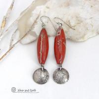 These handmade earrings feature natural red jasper gemstones accented with small hammered sterling silver dangles. The stones have a brick red hue with an interesting matrix of beige streaks and squiggly lines. They have a modern, earthy appeal that coordinates well with all wardrobe styles. They'll make a great gift for a natural stone lover - or a nice addition to your own jewelry wardrobe. They have a coordinating necklace which is sold separately. Handmade in the USA by Silver and Earth Jewelry.  