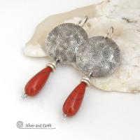These handcrafted sterling silver earrings have a hand stamped texture and feature slender teardrop-shaped red jasper gemstones dangling from the bottom. The stones are a beautiful shade of burnt red with subtle natural black inclusions. The design is modern, contemporary, classic and always in fashion. 