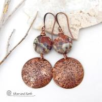 These handcrafted earrings feature natural rhyolite jasper stones accented with copper dangles with a rustic hammered texture. The stones have a natural earthy pattern with various shades of green, rusty orange, brown and cream. They have a casual and earthy style and will make a great gift for a natural stone lover - or a nice addition to your own jewelry wardrobe. Your choice of ear wires. Coordinating necklace sold separately. Handmade in the USA by Silver and Earth Jewelry.