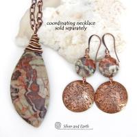 These handcrafted earrings feature natural rhyolite jasper stones accented with copper dangles with a rustic hammered texture. The stones have a natural earthy pattern with various shades of green, rusty orange, brown and cream. They have a casual and earthy style and will make a great gift for a natural stone lover - or a nice addition to your own jewelry wardrobe. Your choice of ear wires. Coordinating necklace sold separately. Handmade in the USA by Silver and Earth Jewelry.