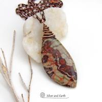 This necklace features a natural rhyolite jasper stone with a natural pattern in earthy hues of rusty orange, brown and taupe. It is wrapped in oxidized copper wire and comes on an 18" copper chain necklace. It has an earthy, natural style and will make a great gift for a natural stone lover - or a nice addition to your own jewelry collection. The chain can be removed from the pendant and worn with other pendants in your wardrobe. Coordinating earrings sold separately. 