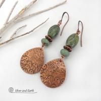 These handcrafted copper earrings have a hammered and hand stamped texture and are accented with green Russian serpentine stones. Russian serpentine is known for its unique natural patterns with light and dark green speckles and web-like patterns. They are accented with small, light green African turquoise stones and copper beads. Bold and unique, they have a boho chic flair and will make a striking statement. Handmade in the USA by Silver and Earth Jewelry.