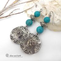 These handcrafted sterling silver earrings have a rustic hammered and hand stamped texture and are accented with a stack of turquoise and sterling silver beads. The silver beads have a fluted corrugated texture and an oxidized satin finish. Bold and striking, they have an earthy organic vibe with southwest style and flair that will look great with all types of outfits. Handmade by Silver and Earth, a New Mexico True Certified business. 