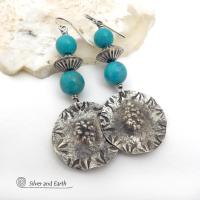 These handcrafted sterling silver earrings have a rustic hammered and hand stamped texture and are accented with a stack of turquoise and sterling silver beads. The silver beads have a fluted corrugated texture and an oxidized satin finish. Bold and striking, they have an earthy organic vibe with southwest style and flair that will look great with all types of outfits. Handmade by Silver and Earth, a New Mexico True Certified business. 