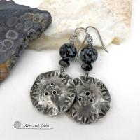 Handcrafted earrings with a modern bold edgy vibe. They feature rustic hammered and hand stamped silver tone pewter dangles accented with natural snowflake obsidian gemstones. The stones have a natural pattern in hues of black and soft gray. This stone is a natural volcanic glass which contains the mineral cristobalite - which creates the "snowflake" type patterns. Bold and striking - they're sure to make a statement. Perfect for women that love natural stones and unique artisan handmade jewelry. 