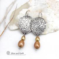 These artisan handcrafted sterling silver earrings have a hand stamped texture and are accented with a stack of dangling 2-tone gold freshwater pearls. They have a modern, contemporary style that looks good with all wardrobe styles -dressed up or down. They'll make a great gift for women that love unique handmade jewelry. 