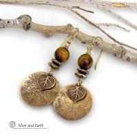 These handcrafted earrings feature gold brass dangles with a lightly hammered texture accented with natural tiger's eye gemstones, brass leaf charms and faceted hematite stones with a sparkly electroplated gold tone finish. The tiger's eye stones also have a faceted cut which casts off a beautiful natural sparkle and shine. They have a modern, elegant chic style that coordinates with all wardrobe styles. Makes a great gift for a nature lover - or a nice addition to your own jewelry wardrobe. 