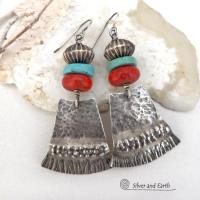 These handcrafted earrings feature hammered and hand stamped sterling silver dangles accented with a stack of natural turquoise stones, fossilized red coral and oxidized sterling silver Native style beads with a rich, corrugated texture. They have a modern, southwestern tribal flair that makes a bold statement. Perfect for women that love the Santa Fe southwest style.The earrings are handmade and are a beautiful example of southwest style jewelry. Handmade by Silver and Earth, a New Mexico True Certified b 