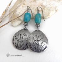 These handcrafted earrings feature silver pewter teardrop-shaped dangles with a hand stamped feather texture accented with natural turquoise stones and small stainless steel beads. They have a modern earthy style with lots of boho chic southwestern flair. They'll make a great gift for anyone that loves natural turquoise stones and southwest style jewelry. Handmade in the USA by Silver and Earth jewelry, a NM True Certfied Business. 