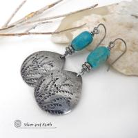 These handcrafted earrings feature silver pewter teardrop-shaped dangles with a hand stamped feather texture accented with natural turquoise stones and small stainless steel beads. They have a modern earthy style with lots of boho chic southwestern flair. They'll make a great gift for anyone that loves natural turquoise stones and southwest style jewelry. Handmade in the USA by Silver and Earth jewelry, a NM True Certfied Business. 