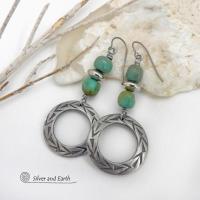 These handcrafted earrings feature silver pewter hoops with a hand stamped texture accented with natural, genuine turquoise stones and silver plated beads. Lightweight and comfortable to wear, they have an earthy modern style with southwest flair that coordinates beautifully with all wardrobe types. Handmade in the USA by Silver and Earth Jewelry, a Certified New Mexico True business.