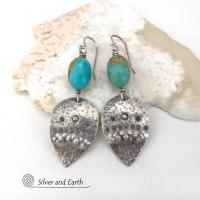 These handcrafted earrings feature natural turquoise nuggets accented with sterling silver dangles with a hammered and hand stamped texture. The stones are a gorgeous shade of turquoise with a natural copper matrix. They have an earthy organic, modern style with southwestern flair. The earrings are handmade and are a beautiful example of southwest style jewelry. Handmade by Silver and Earth, a New Mexico True Certified business.