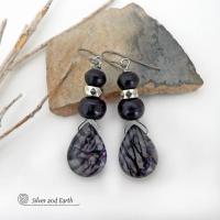 The earrings feature natural zebra jasper stones accented with black beads and silver plated beads and dangle from hypoallergenic titanium ear wires. This stone is known as zebra jasper because of the natural striped matrix that resembles a zebra's pattern. It's a striking stone with earthy hues of soft gray, along with streaks of black. They'll make a great gift for a natural stone lover - or a nice addition to your own jewelry wardrobe. Handmade in the USA by Silver and Earth Jewelry. 