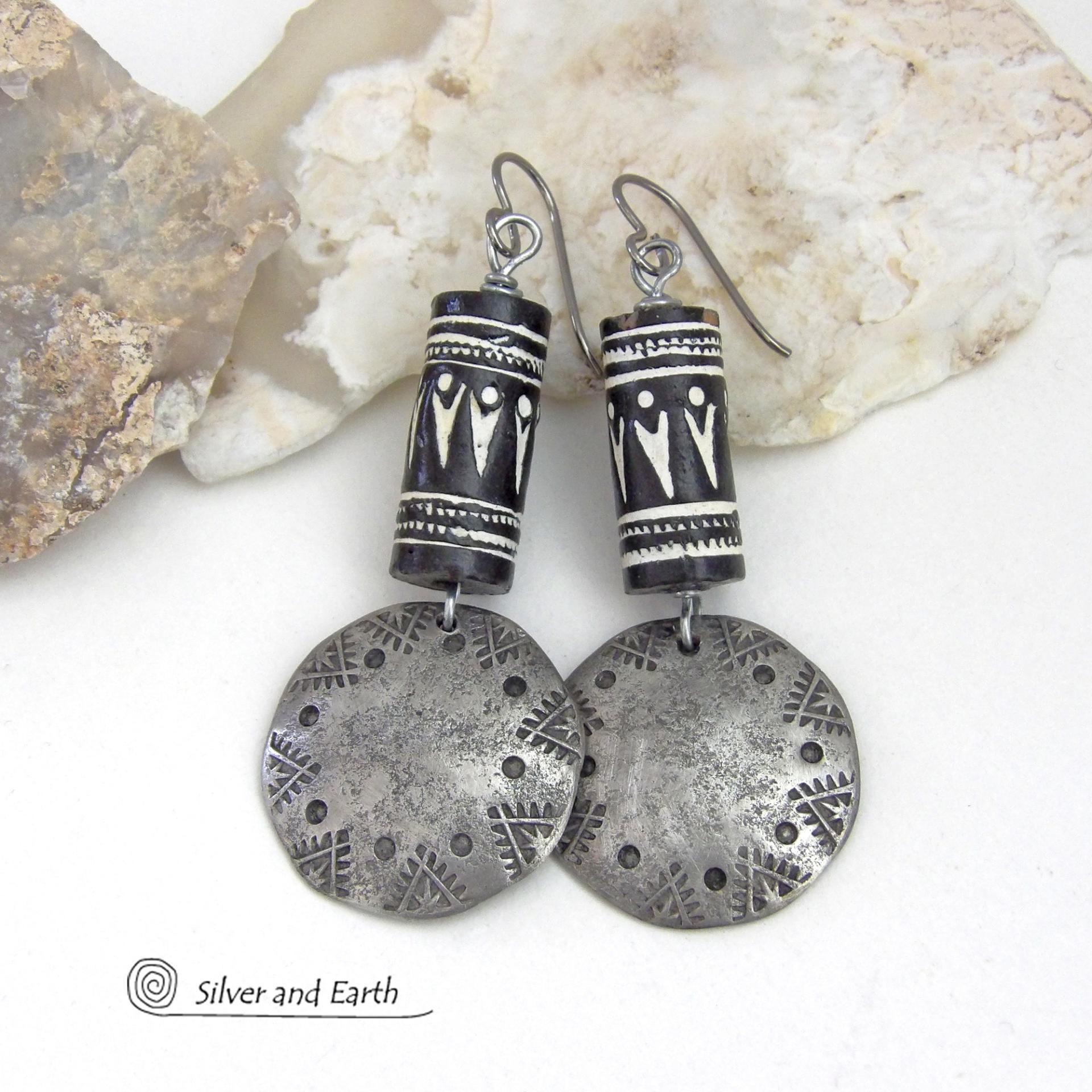 These silver pewter earrings have a rustic, hammered and hand stamped texture and are accented with handmade African tube-shaped beads with a striking black and white pattern. Bold and striking, they'll make a ethnic tribal statement. Perfect for women that unique and one of a kind artisan handcrafted jewelry. Handmade in the USA by Silver and Earth Jewelry.