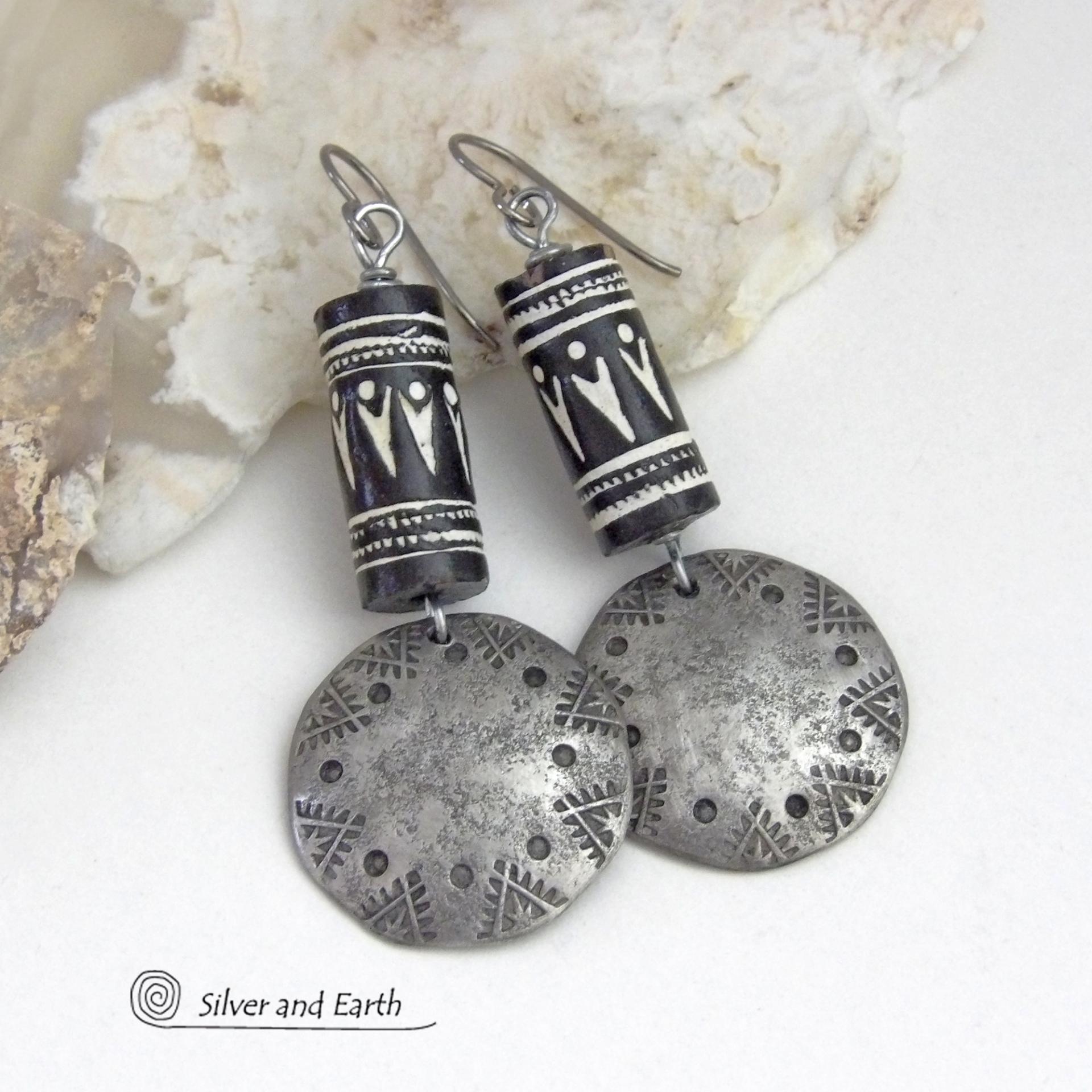 These silver pewter earrings have a rustic, hammered and hand stamped texture and are accented with handmade African tube-shaped beads with a striking black and white pattern. Bold and striking, they'll make a ethnic tribal statement. Perfect for women that unique and one of a kind artisan handcrafted jewelry. Handmade in the USA by Silver and Earth Jewelry.