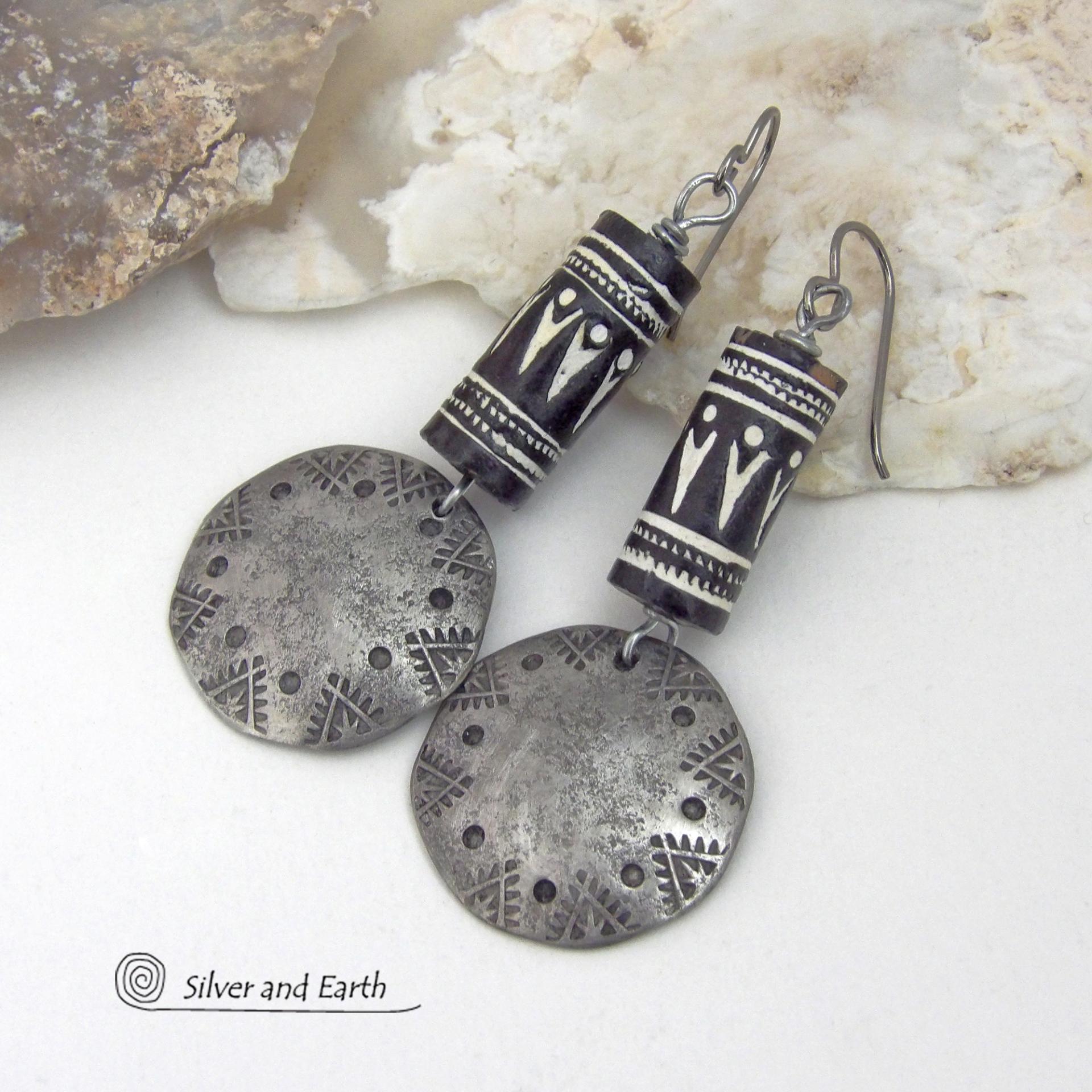 These silver pewter earrings have a rustic, hammered and hand stamped texture and are accented with handmade African tube-shaped beads with a striking black and white pattern. Bold and striking, they'll make a ethnic tribal statement. Perfect for women that unique and one of a kind artisan handcrafted jewelry. Handmade in the USA by Silver and Earth Jewelry.