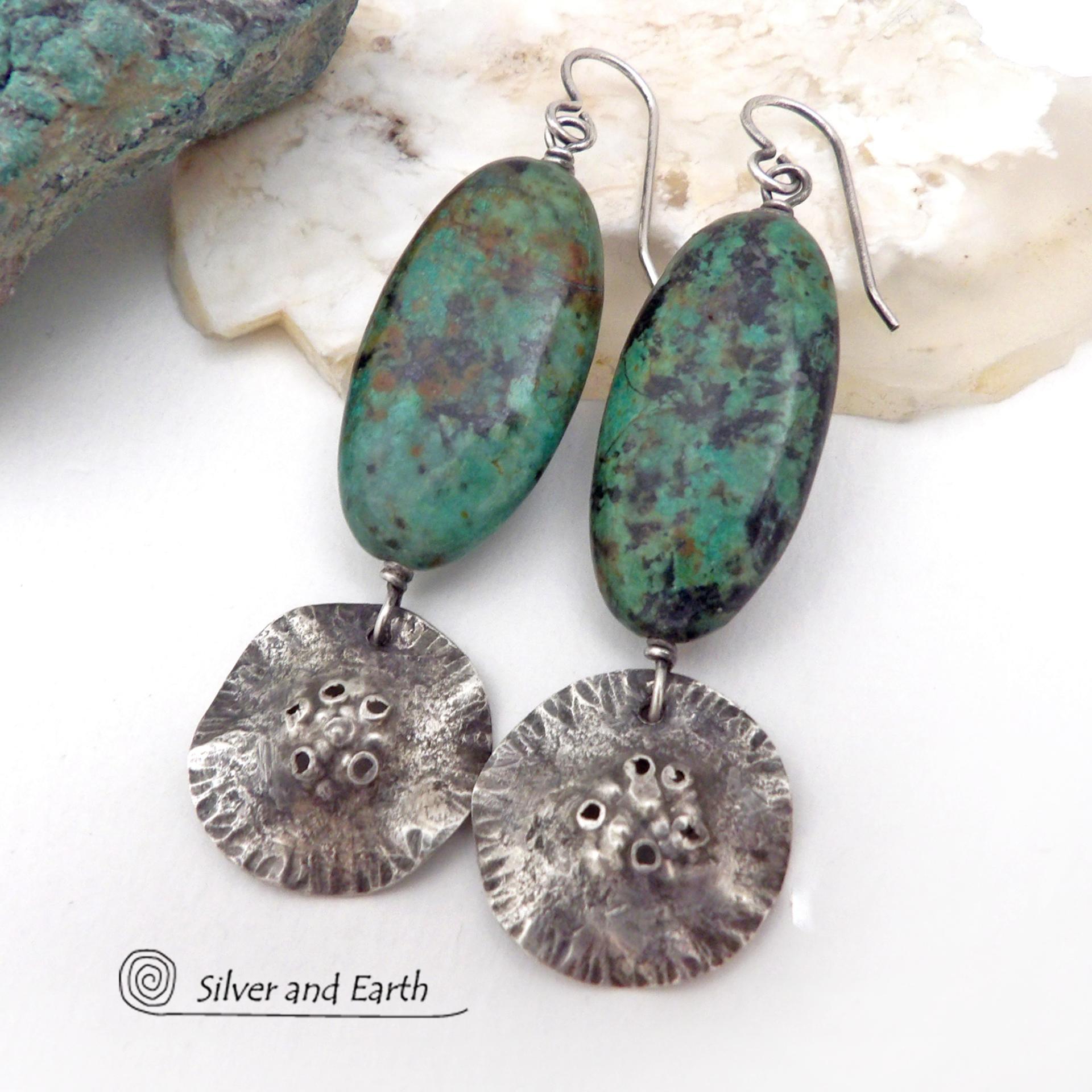 Big, long natural African turquoise stones are accented with rustic hammered sterling silver dangles in these one-of-a-kind earrings. They have an earthy, organic style and are perfect for anyone that loves natural stones and unique handcrafted artisan jewelry. I hand sawed the dangles out of solid sterling silver sheet; hammered them for texture; crimped the edges for a ruffled effect; then added a few holes for a rustic vibe. Handmade in the USA by Silver and Earth Jewelry.