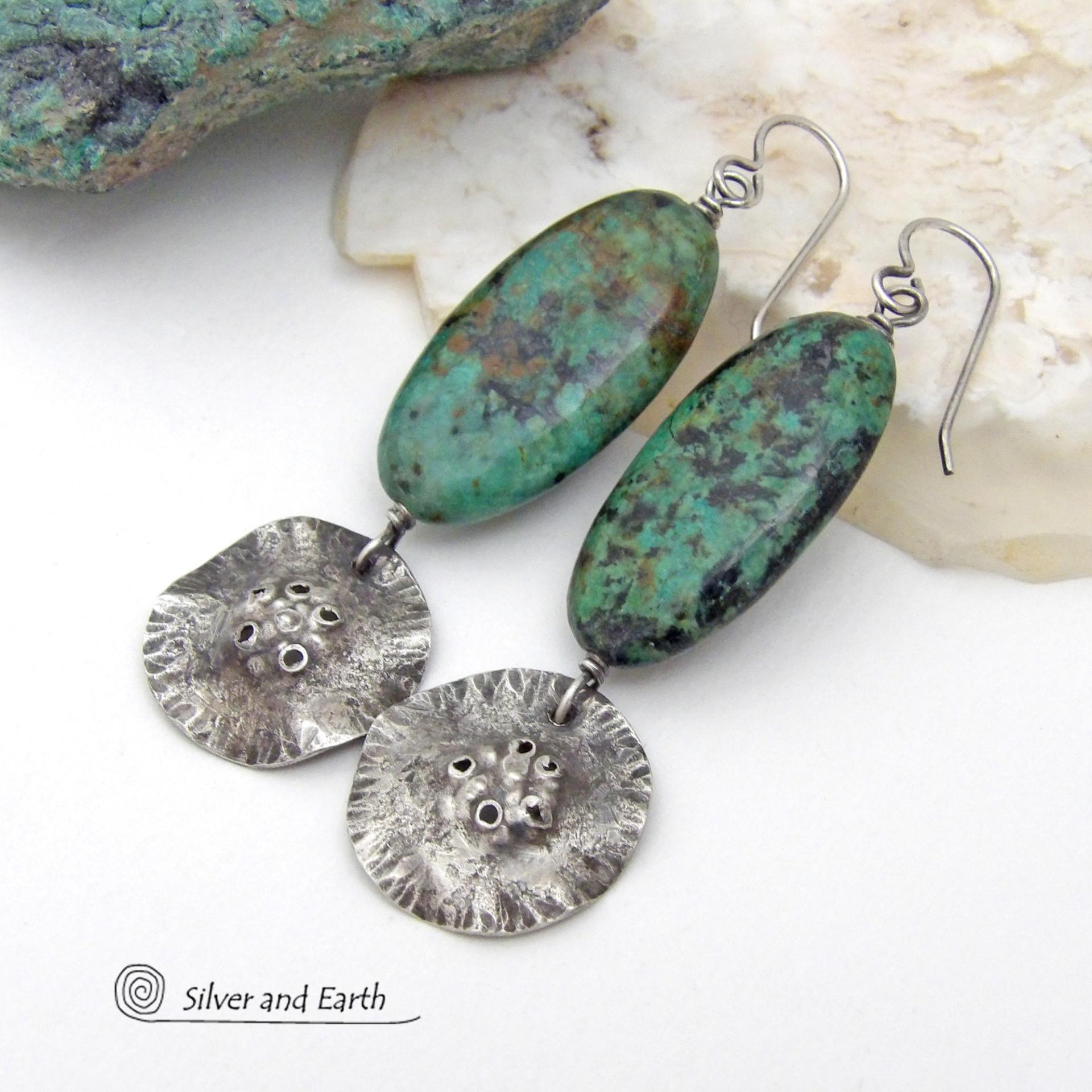 Big, long natural African turquoise stones are accented with rustic hammered sterling silver dangles in these one-of-a-kind earrings. They have an earthy, organic style and are perfect for anyone that loves natural stones and unique handcrafted artisan jewelry. I hand sawed the dangles out of solid sterling silver sheet; hammered them for texture; crimped the edges for a ruffled effect; then added a few holes for a rustic vibe. Handmade in the USA by Silver and Earth Jewelry.