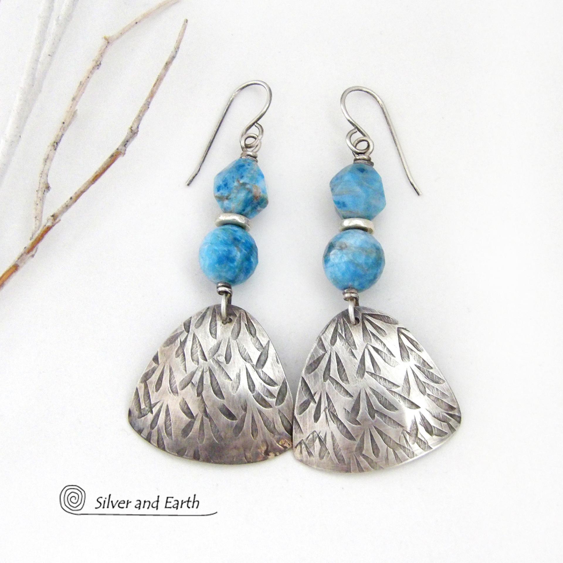 These handcrafted sterling silver dangle earrings have a hand stamped texture and are accented with natural apatite gemstones. The stones have a beautiful blue hue and the ones on top have a faceted nugget finish. They have an elegant, modern style that looks great with all wardrobe styles - dressed up or down.