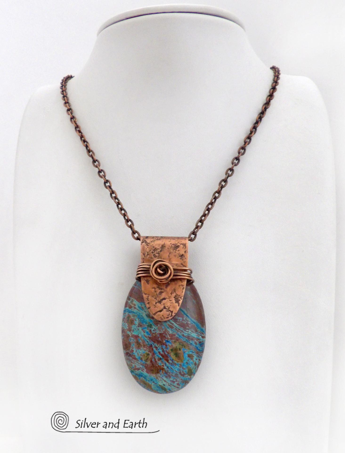 This pendant necklace features a beautiful aqua jasper gemstone with stunning hues of blue and brown accented with a hand forged copper bail with a lightly hammered texture. It's accented with twists of solid copper wire which forms a spiral in front. Unique and one-of-a-kind, it makes a great gift for a natural stone lover - or a nice addition to your own jewelry collection.